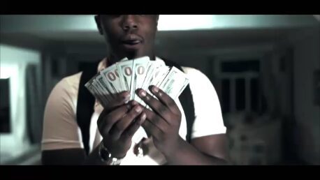 Blizz Vito holding money in rap music video