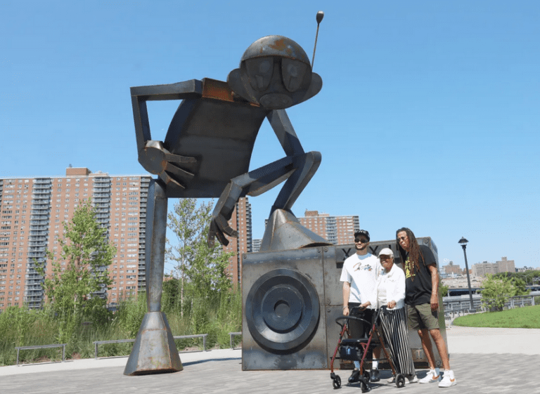 a group of people standing in front of a statue