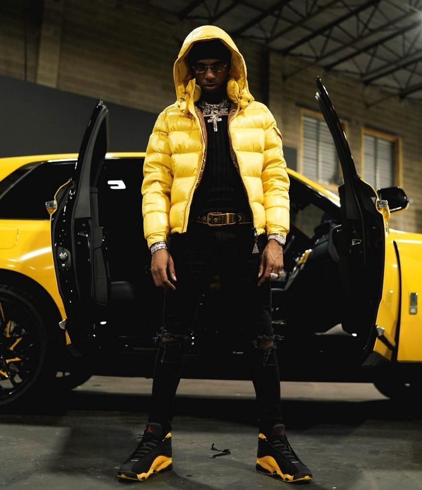 Key Glock: The Heir To The PRE Empire 5 A picture containing person, yellow, carDescription automatically generated