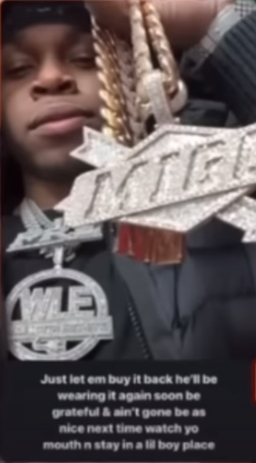 A person holding a medal
Description automatically generated