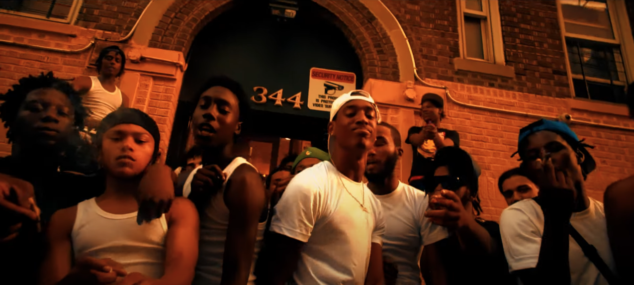 A group of people standing in front of a building

Description automatically generated