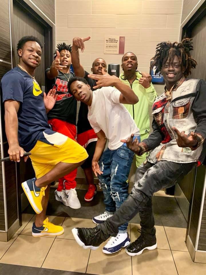 A group of people posing for a photo

Description automatically generated