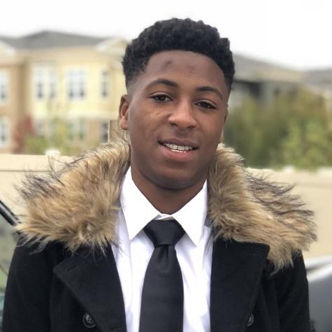 A person wearing a suit and tie

Description automatically generated