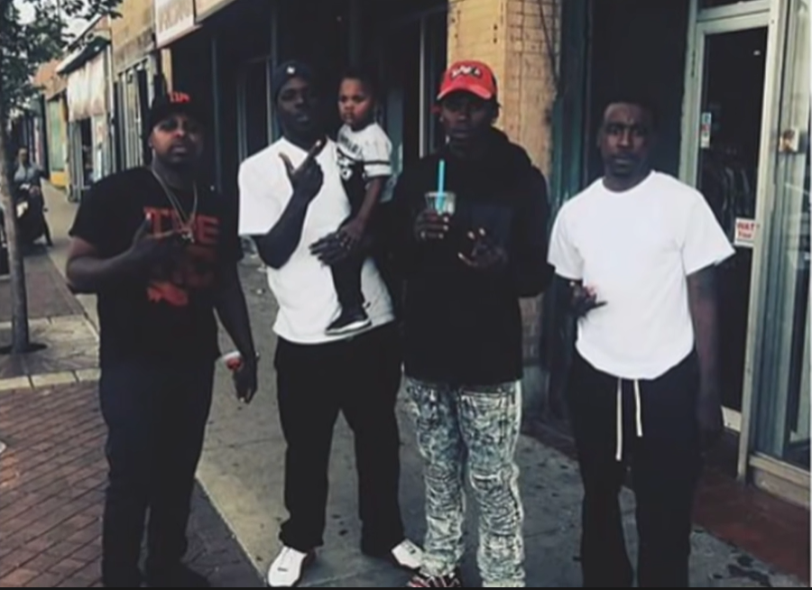The Legacy Of T.Roy: The Chiraq Rambo 59 A group of men standing outside a building
Description automatically generated with medium confidence