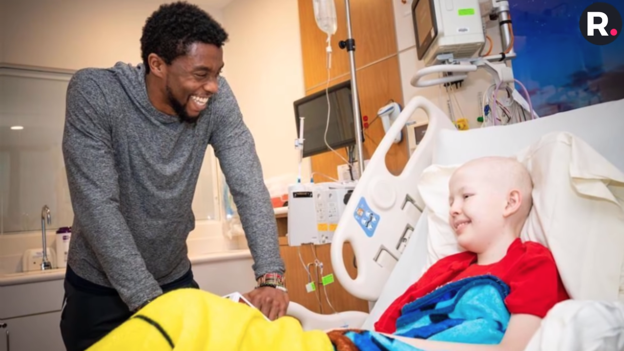 A person standing next to a child in a hospital bed

Description automatically generated with medium confidence