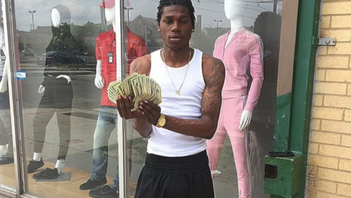 The Legacy Of T.Roy: The Chiraq Rambo 61 A person holding a pineapple
Description automatically generated with medium confidence