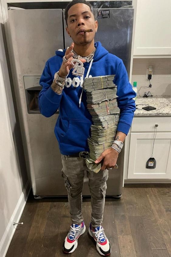 Key Glock: The Heir To The PRE Empire 21 A person holding a snakeDescription automatically generated with low confidence