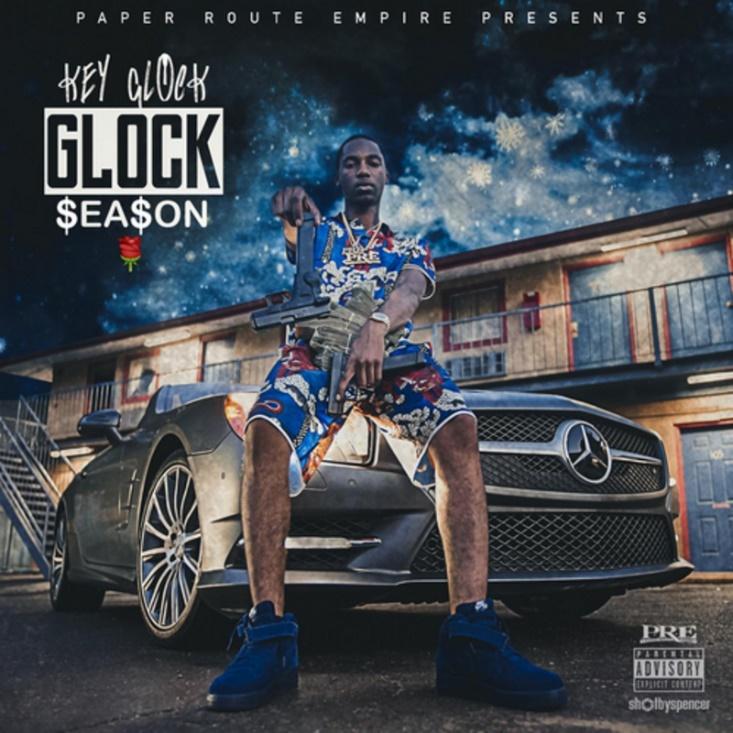 Key Glock: The Heir To The PRE Empire 13 A person sitting on a carDescription automatically generated with medium confidence