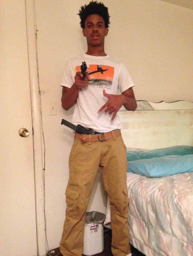 A person holding a gun

Description automatically generated with medium confidence