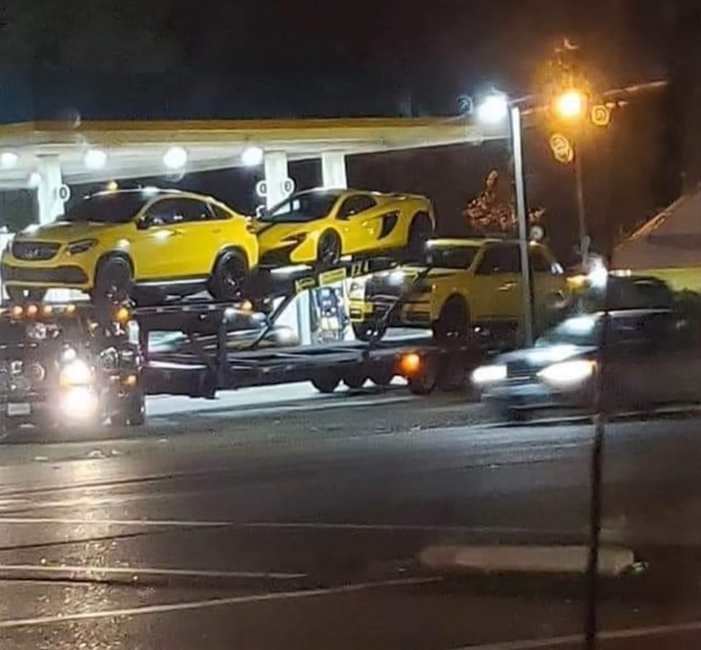 Key Glock: The Heir To The PRE Empire 37 A group of cars parked in a parking lot at nightDescription automatically generated with medium confidence
