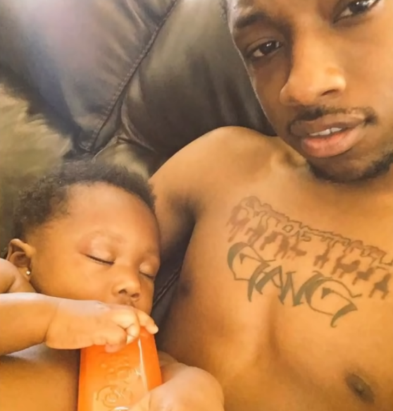 The Legacy Of T.Roy: The Chiraq Rambo 51 A person holding a baby
Description automatically generated with medium confidence