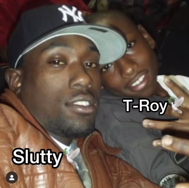 The Legacy Of T.Roy: The Chiraq Rambo 4 A person kissing another person on the cheek
Description automatically generated with medium confidence