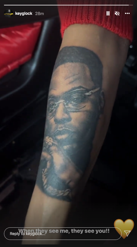 Key Glock: The Heir To The PRE Empire 42 A picture containing text, tattoo, indoorDescription automatically generated