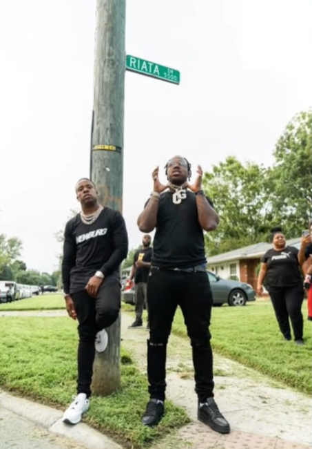 <strong>EST GEE: From Pro Athlete To Drug Kingpin To Rap Superstar</strong> 32 A picture containing grass, sky, outdoor, person
Description automatically generated