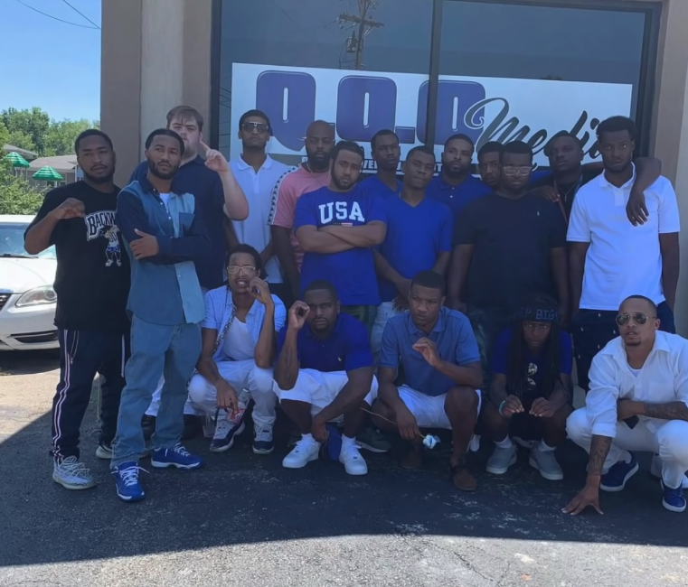 <strong>EST GEE: From Pro Athlete To Drug Kingpin To Rap Superstar</strong> 13 A group of people posing for a photo
Description automatically generated